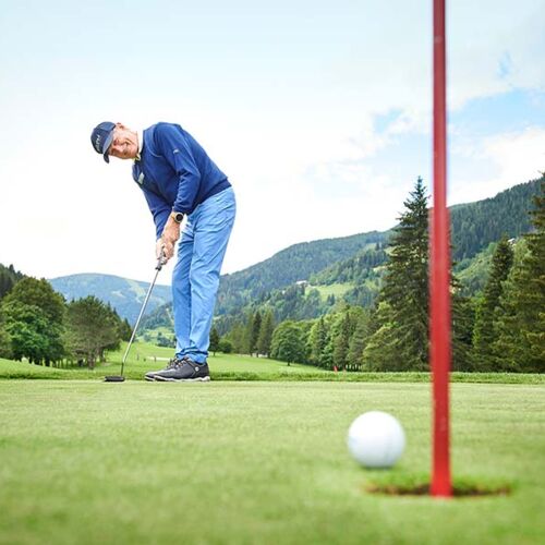Franz Klammer hits his golf ball into the hole on a golfing holiday in Bad Kleinkirchheim